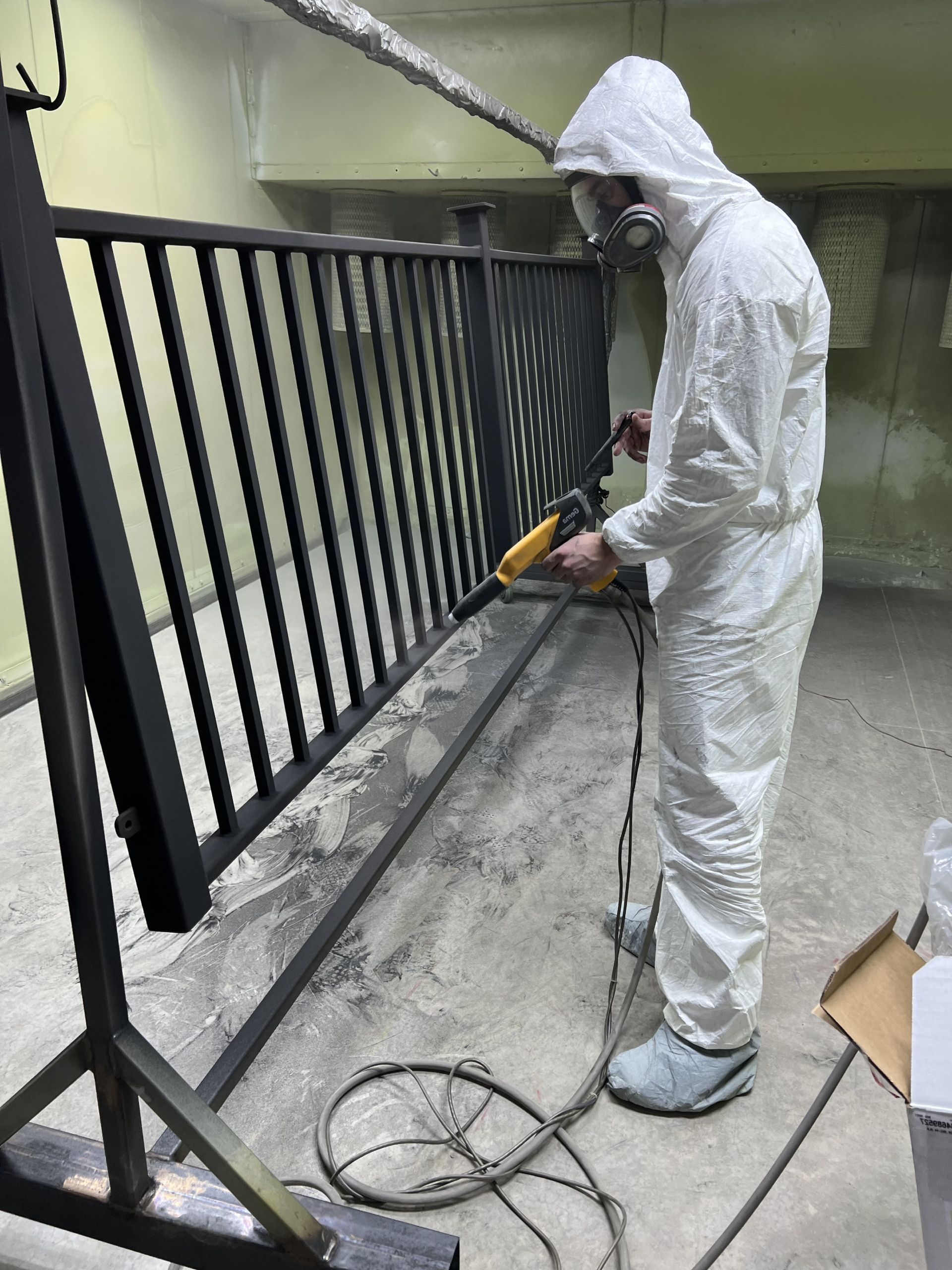 worker powder coating fence